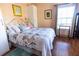 Guest bedroom with floral bedding and wood floors at 3653 Kings Rd # 101, Palm Harbor, FL 34685