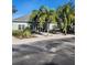Community clubhouse with landscaping and palm trees at 3653 Kings Rd # 101, Palm Harbor, FL 34685