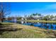 Scenic community lake view with fountain, lush green spaces, and palm trees at 3653 Kings Rd # 101, Palm Harbor, FL 34685