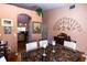 Open dining area with hardwood floors, view into kitchen and hallway at 3653 Kings Rd # 101, Palm Harbor, FL 34685