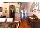 Open dining area with hardwood floors, view into kitchen and hallway at 3653 Kings Rd # 101, Palm Harbor, FL 34685