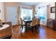 Spacious dining room with hardwood floors and large windows at 3653 Kings Rd # 101, Palm Harbor, FL 34685