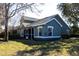 Rear view of charming house, showcasing screened patio and well-maintained lawn at 3653 Kings Rd # 101, Palm Harbor, FL 34685