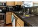 Modern kitchen with stainless steel appliances and dark countertops at 3653 Kings Rd # 101, Palm Harbor, FL 34685