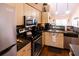 Updated kitchen with stainless steel appliances and wood flooring at 3653 Kings Rd # 101, Palm Harbor, FL 34685