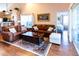 Living room with leather sofas and a view into bedroom at 3653 Kings Rd # 101, Palm Harbor, FL 34685