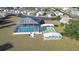 Aerial view of community pool and shuffleboard courts at 37347 Derbyshire Dr, Zephyrhills, FL 33542