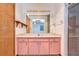 Bathroom with pink vanity, large mirror and shower at 37347 Derbyshire Dr, Zephyrhills, FL 33542