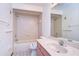 Bathroom with tub, shower and pink vanity at 37347 Derbyshire Dr, Zephyrhills, FL 33542
