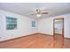 Bright bedroom with hardwood floors, ceiling fan, and walk-in closet at 37347 Derbyshire Dr, Zephyrhills, FL 33542