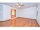Bedroom with hardwood floors, ceiling fan and en-suite bathroom at 37347 Derbyshire Dr, Zephyrhills, FL 33542