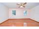 Bright bedroom featuring hardwood floors and ceiling fan at 37347 Derbyshire Dr, Zephyrhills, FL 33542