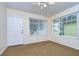 Bright entry room with carpet, neutral walls, and two windows at 37347 Derbyshire Dr, Zephyrhills, FL 33542