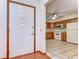 Shows the entryway and kitchen with hardwood floors and wood cabinets at 37347 Derbyshire Dr, Zephyrhills, FL 33542