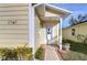 House's front door entry with walkway and landscaping at 37347 Derbyshire Dr, Zephyrhills, FL 33542