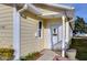 Front door entry with a white door and small porch at 37347 Derbyshire Dr, Zephyrhills, FL 33542