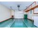 Garage with overhead storage, door opener, and utility sink at 37347 Derbyshire Dr, Zephyrhills, FL 33542