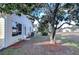 Backyard view showcasing a house with mature trees and landscaping at 37347 Derbyshire Dr, Zephyrhills, FL 33542