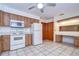 Kitchen with white appliances and wood cabinets at 37347 Derbyshire Dr, Zephyrhills, FL 33542