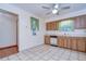 Kitchen boasts wood cabinets, white appliances and tile floor at 37347 Derbyshire Dr, Zephyrhills, FL 33542