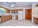 Kitchen features wood cabinets, white appliances, and tile flooring at 37347 Derbyshire Dr, Zephyrhills, FL 33542
