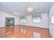 Living room with hardwood floors, sliding glass doors and chandelier at 37347 Derbyshire Dr, Zephyrhills, FL 33542