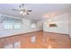 Spacious living room featuring hardwood floors and ceiling fan at 37347 Derbyshire Dr, Zephyrhills, FL 33542