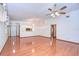 Spacious living room with hardwood floors and multiple windows at 37347 Derbyshire Dr, Zephyrhills, FL 33542