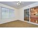 Sunroom features carpet, ceiling fan, and sliding glass doors at 37347 Derbyshire Dr, Zephyrhills, FL 33542