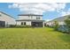 Spacious backyard with grassy lawn and home view at 4062 Cadence Loop, Land O Lakes, FL 34638