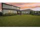 Spacious backyard with green grass, a screened patio, and a fence at 4062 Cadence Loop, Land O Lakes, FL 34638