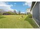 Large backyard with grassy area and playground equipment at 4062 Cadence Loop, Land O Lakes, FL 34638