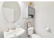 Small bathroom with white vanity, oval mirror, and gray storage cabinet at 4062 Cadence Loop, Land O Lakes, FL 34638