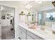 Double vanity bathroom with a large mirror and a walk-in shower at 4062 Cadence Loop, Land O Lakes, FL 34638