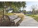 Wooden park bench nestled within a tree-lined community park at 4062 Cadence Loop, Land O Lakes, FL 34638