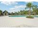Community pool with adjacent clubhouse and landscaping at 4062 Cadence Loop, Land O Lakes, FL 34638