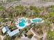 Aerial view of resort-style pool with lounge chairs and a clubhouse at 4062 Cadence Loop, Land O Lakes, FL 34638