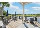 Community deck overlooking a lake with tables and chairs at 4062 Cadence Loop, Land O Lakes, FL 34638
