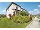 Two-story house with a white facade, landscaping, and a walkway at 4062 Cadence Loop, Land O Lakes, FL 34638