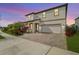 Two-story house with a white facade, paver driveway, and landscaping at 4062 Cadence Loop, Land O Lakes, FL 34638