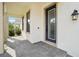 Front porch with pavers, a dark door, and columns at 4062 Cadence Loop, Land O Lakes, FL 34638