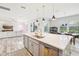 Open kitchen with large island, stainless steel appliances, and white quartz countertops at 4062 Cadence Loop, Land O Lakes, FL 34638