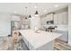 Bright kitchen with island, stainless steel appliances, and gray shaker cabinets at 4062 Cadence Loop, Land O Lakes, FL 34638