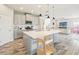 Modern kitchen features a large island with quartz countertops and stainless steel appliances at 4062 Cadence Loop, Land O Lakes, FL 34638
