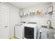 Convenient laundry room with washer, dryer, and storage shelves at 4062 Cadence Loop, Land O Lakes, FL 34638