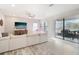 Open living room with tile floors, sectional sofa, and sliding doors to the patio at 4062 Cadence Loop, Land O Lakes, FL 34638