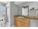 Bright bathroom with shower, toilet and wood vanity at 5708 Bayshore Dr, Seminole, FL 33772