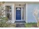 Blue front door with glass accents and a walkway at 5708 Bayshore Dr, Seminole, FL 33772