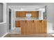 Kitchen with wood cabinets, white appliances, and a breakfast bar at 5708 Bayshore Dr, Seminole, FL 33772