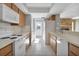 Galley style kitchen, white appliances and wood cabinets at 5708 Bayshore Dr, Seminole, FL 33772
